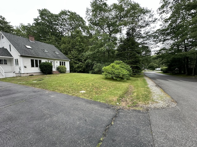 53 Pennacook Cir, Wells, ME 04090 - view of home's exterior with a yard, roof with shingles, and a chimney