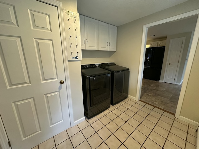 53 Pennacook Cir, Wells, ME 04090 - laundry room featuring washing machine and dryer, cabinet space, and light tile patterned floors