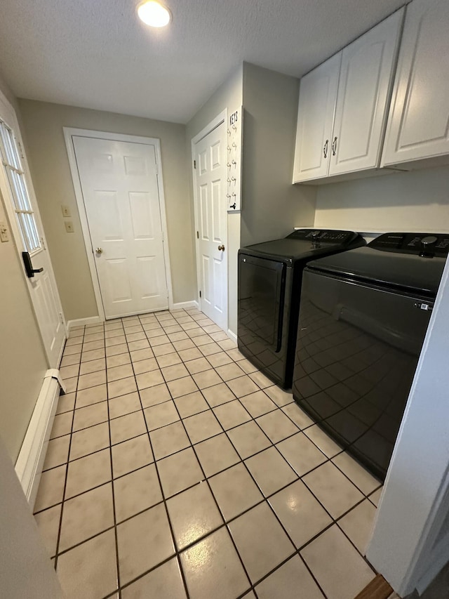 53 Pennacook Cir, Wells, ME 04090 - laundry area with washer and dryer, cabinet space, a textured ceiling, a baseboard heating unit, and light tile patterned flooring