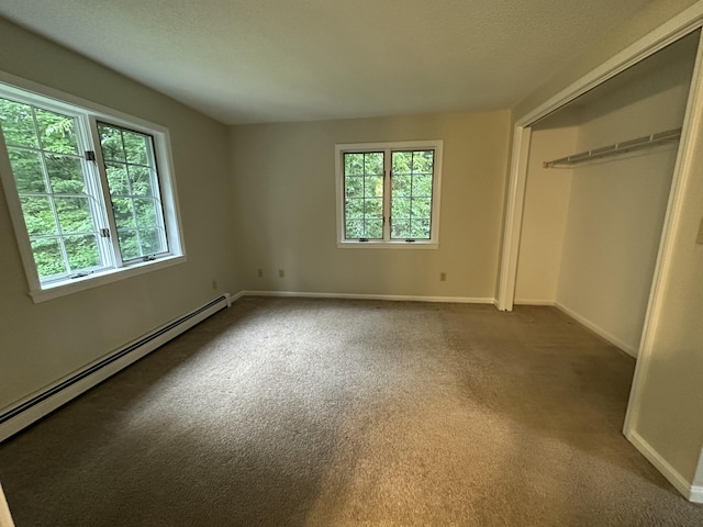 53 Pennacook Cir, Wells, ME 04090 - unfurnished bedroom with multiple windows, a baseboard heating unit, and carpet flooring