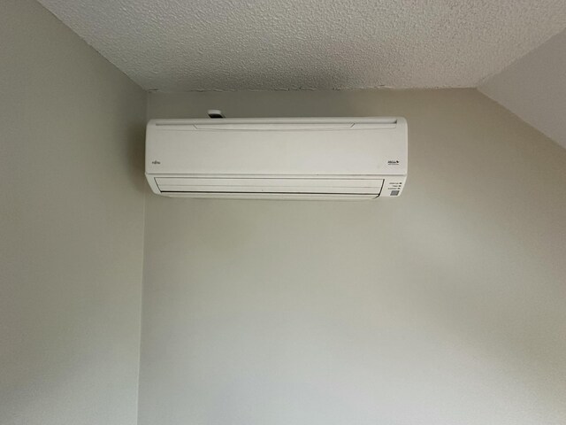 53 Pennacook Cir, Wells, ME 04090 - detailed view of a wall mounted air conditioner and a textured ceiling
