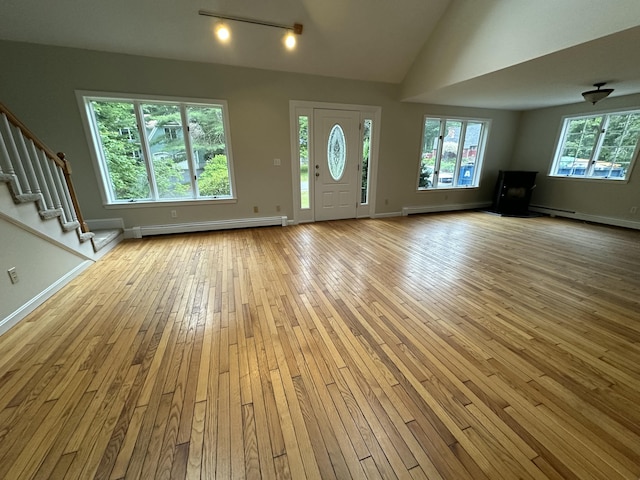 53 Pennacook Cir, Wells, ME 04090 - entryway with a baseboard radiator, hardwood / wood-style floors, stairs, and lofted ceiling