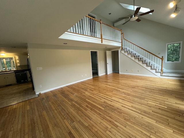 53 Pennacook Cir, Wells, ME 04090 - unfurnished living room featuring high vaulted ceiling, hardwood / wood-style floors, stairs, and a ceiling fan