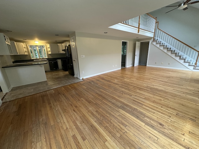 53 Pennacook Cir, Wells, ME 04090 - unfurnished living room with hardwood / wood-style floors, stairway, and a ceiling fan