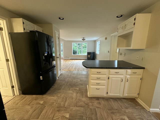 53 Pennacook Cir, Wells, ME 04090 - kitchen with black refrigerator with ice dispenser, a peninsula, dark countertops, white cabinets, and open floor plan