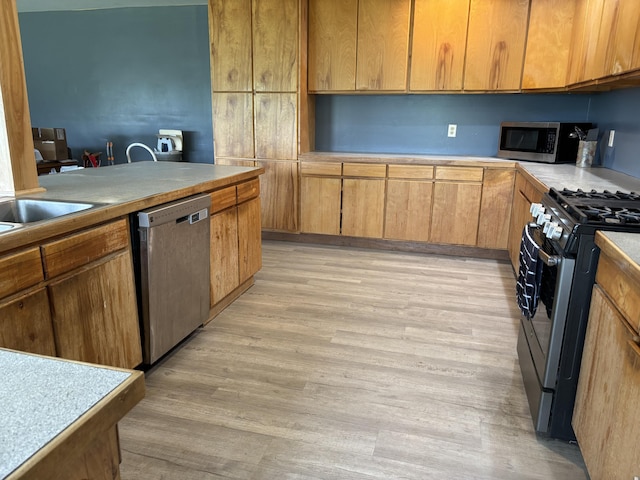 440 Temple Rd, Wilton, ME 04294 - kitchen with appliances with stainless steel finishes, light wood-style flooring, and light countertops