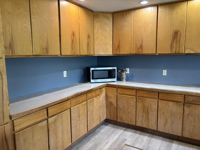 440 Temple Rd, Wilton, ME 04294 - kitchen with stainless steel microwave, light wood-style floors, light countertops, recessed lighting, and brown cabinets