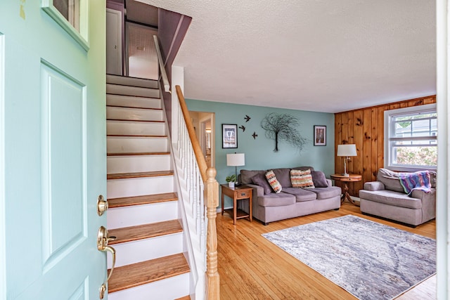51 Burwell Ave, South Portland, ME 04106 - living area with stairway, a textured ceiling, and light wood-style flooring