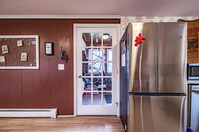 51 Burwell Ave, South Portland, ME 04106 - doorway with a baseboard radiator, wood finished floors, and wood walls