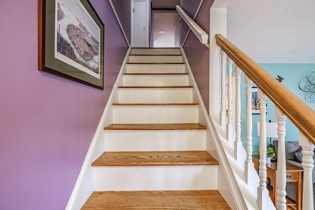 51 Burwell Ave, South Portland, ME 04106 - staircase with a textured ceiling