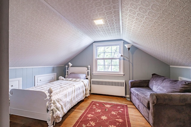 51 Burwell Ave, South Portland, ME 04106 - bedroom with radiator, wood finished floors, an ornate ceiling, and vaulted ceiling