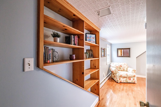 51 Burwell Ave, South Portland, ME 04106 - corridor with baseboard heating, wood finished floors, and an ornate ceiling