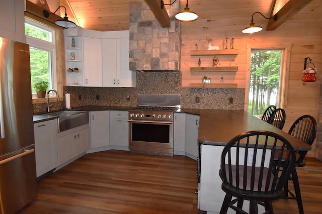 107 Shady Ln, Newport, ME 04953 - kitchen featuring appliances with stainless steel finishes, open shelves, dark countertops, a peninsula, and a wood ceiling with exposed beams
