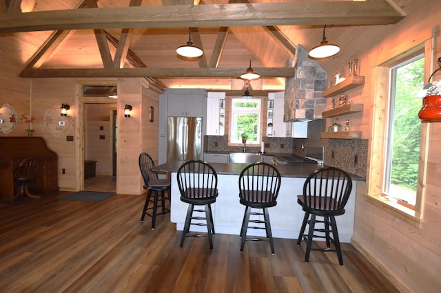 107 Shady Ln, Newport, ME 04953 - kitchen featuring dark countertops, stainless steel refrigerator, a peninsula, dark wood-type flooring, and open shelves