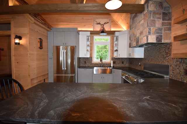 107 Shady Ln, Newport, ME 04953 - kitchen featuring stainless steel refrigerator, open shelves, backsplash, dark stone countertops, and wood walls