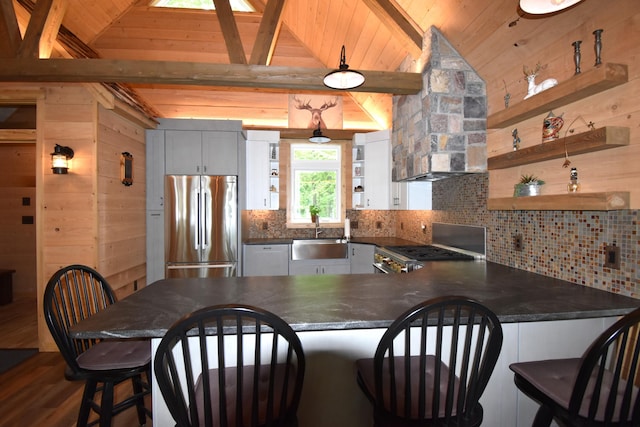107 Shady Ln, Newport, ME 04953 - kitchen with stainless steel refrigerator, dark countertops, open shelves, a peninsula, and range