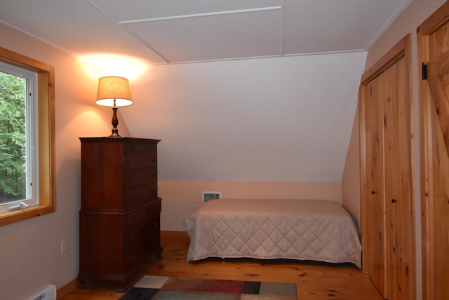 107 Shady Ln, Newport, ME 04953 - bedroom with light wood finished floors and a baseboard heating unit