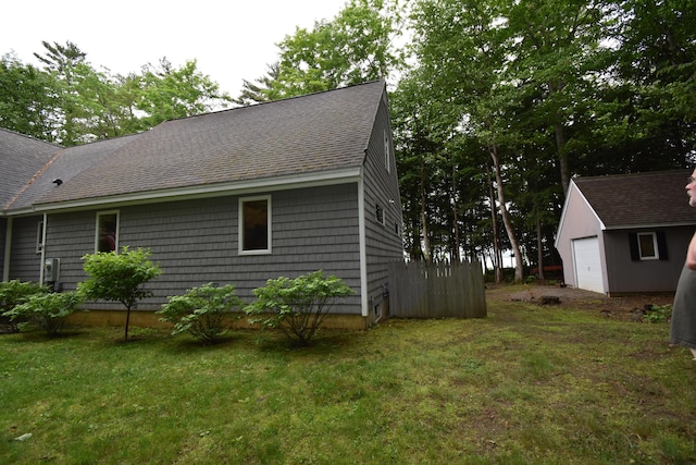 107 Shady Ln, Newport, ME 04953 - view of side of property featuring roof with shingles, a yard, and an outdoor structure