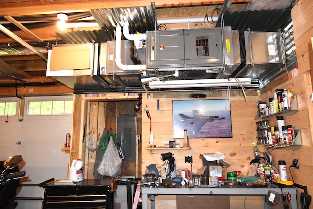 107 Shady Ln, Newport, ME 04953 - garage with electric panel, wood walls, and a workshop area