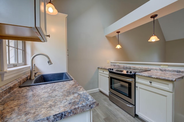4 Cheshire Meadows Ln Unit 4, Kennebunk, ME 04043 - kitchen with stainless steel electric range oven, a peninsula, light wood-type flooring, hanging light fixtures, and white cabinets