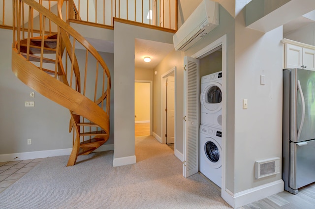 4 Cheshire Meadows Ln Unit 4, Kennebunk, ME 04043 - laundry room with estacked washer and dryer and a wall unit AC