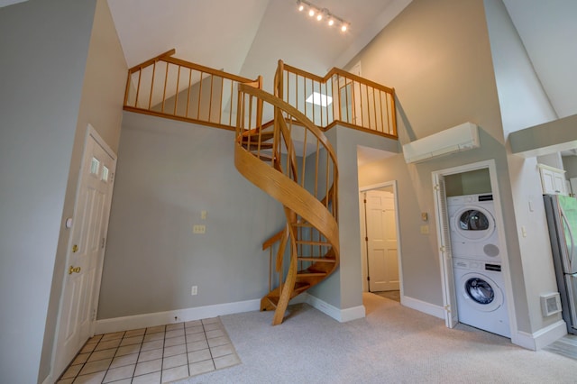 4 Cheshire Meadows Ln Unit 4, Kennebunk, ME 04043 - laundry area featuring stacked washing machine and dryer, a high ceiling, light carpet, and rail lighting