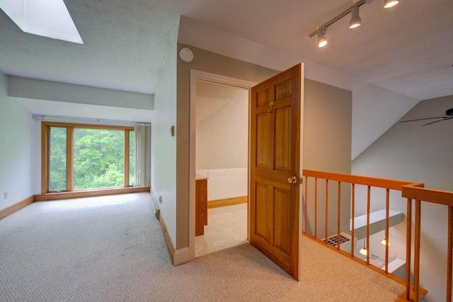 4 Cheshire Meadows Ln Unit 4, Kennebunk, ME 04043 - corridor with rail lighting, light carpet, a skylight, an upstairs landing, and lofted ceiling