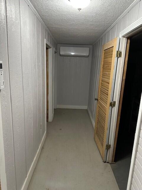 2073 Western Ave, Newburgh, ME 04444 - hallway featuring a textured ceiling and wood walls