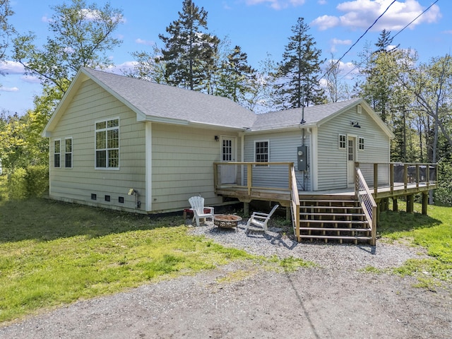 665 Hendricks Hill Rd, Southport, ME 04576 - back of house with a fire pit, a deck, roof with shingles, and a yard
