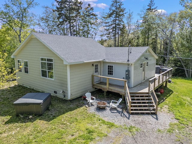 665 Hendricks Hill Rd, Southport, ME 04576 - rear view of house with a hot tub, an outdoor fire pit, a shingled roof, a wooden deck, and a yard
