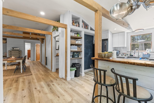 665 Hendricks Hill Rd, Southport, ME 04576 - kitchen featuring white cabinetry, tasteful backsplash, light wood finished floors, butcher block counters, and recessed lighting