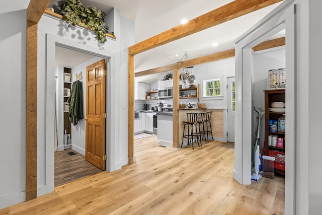 665 Hendricks Hill Rd, Southport, ME 04576 - hallway with light wood-type flooring, beam ceiling, and recessed lighting