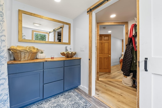 665 Hendricks Hill Rd, Southport, ME 04576 - bathroom with wood finished floors, vanity, and recessed lighting