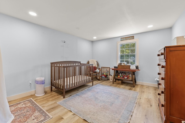 665 Hendricks Hill Rd, Southport, ME 04576 - bedroom featuring light wood-type flooring, recessed lighting, and a nursery area