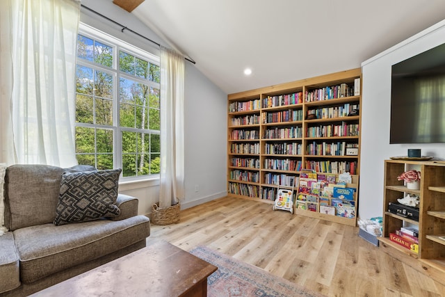665 Hendricks Hill Rd, Southport, ME 04576 - sitting room with plenty of natural light, vaulted ceiling, wood finished floors, and bookshelves