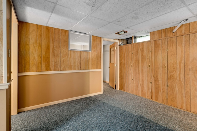 94 Depot St, Waldoboro, ME 04572 - below grade area featuring wood walls, a drop ceiling, and carpet