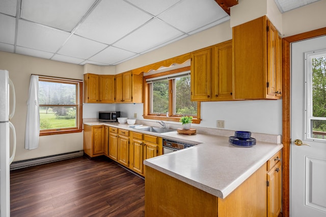 94 Depot St, Waldoboro, ME 04572 - kitchen with baseboard heating, stainless steel microwave, light countertops, dark wood finished floors, and a drop ceiling