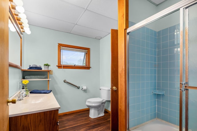 94 Depot St, Waldoboro, ME 04572 - bathroom featuring vanity, wood finished floors, shower / bath combination with glass door, and a drop ceiling