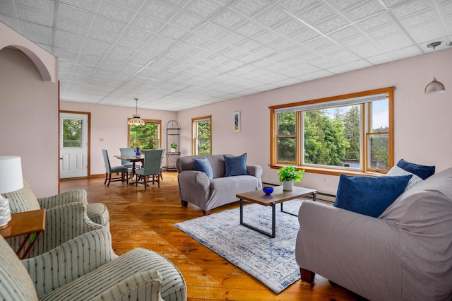 94 Depot St, Waldoboro, ME 04572 - living room with wood-type flooring, healthy amount of natural light, and a baseboard radiator