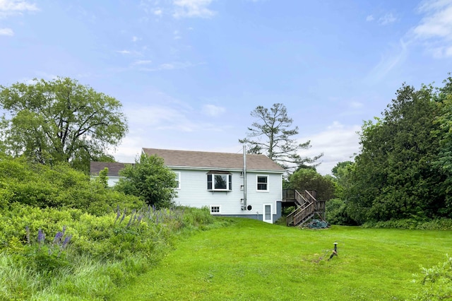 94 Depot St, Waldoboro, ME 04572 - rear view of property featuring stairway, a wooden deck, and a yard