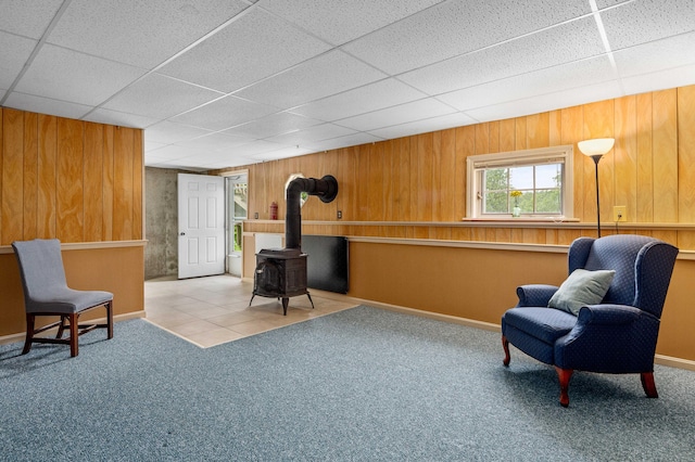 94 Depot St, Waldoboro, ME 04572 - living area with a wood stove, carpet floors, a drop ceiling, and wooden walls