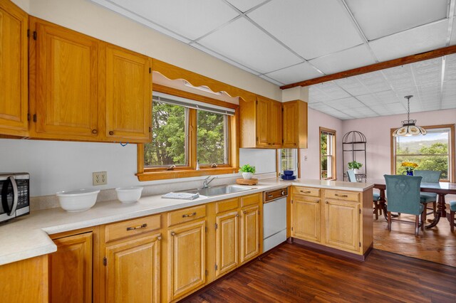 94 Depot St, Waldoboro, ME 04572 - kitchen with white dishwasher, stainless steel microwave, light countertops, a peninsula, and dark wood-style floors