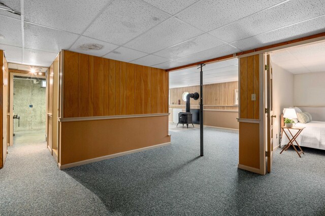 94 Depot St, Waldoboro, ME 04572 - finished below grade area with carpet floors, a wood stove, a paneled ceiling, and wood walls