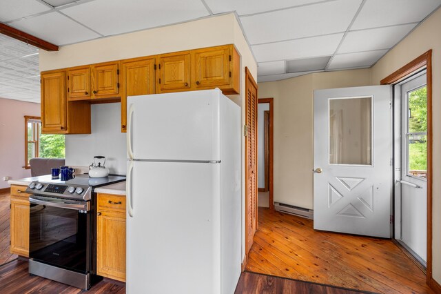 94 Depot St, Waldoboro, ME 04572 - kitchen with freestanding refrigerator, electric stove, dark wood finished floors, baseboard heating, and a paneled ceiling