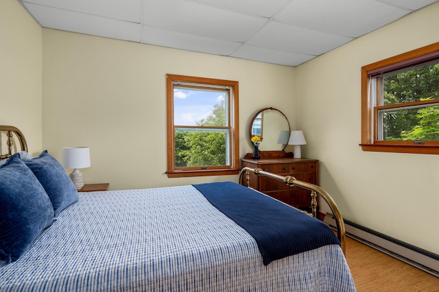 94 Depot St, Waldoboro, ME 04572 - bedroom with a baseboard radiator, a paneled ceiling, and wood finished floors