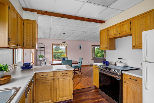 94 Depot St, Waldoboro, ME 04572 - kitchen with electric stove, freestanding refrigerator, dark wood-style floors, light countertops, and a peninsula