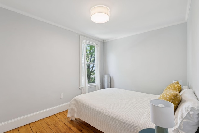 32 State St Unit 5, Portland, ME 04101 - bedroom featuring radiator heating unit, light wood finished floors, and ornamental molding