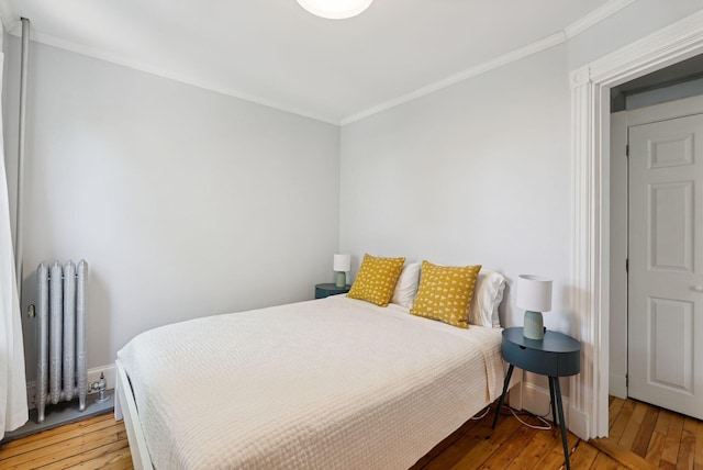 32 State St Unit 5, Portland, ME 04101 - bedroom with radiator, light wood finished floors, and ornamental molding