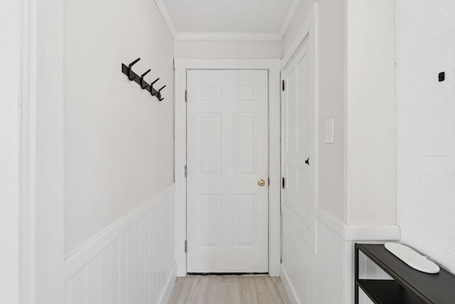 32 State St Unit 5, Portland, ME 04101 - doorway featuring crown molding, light wood-style flooring, a decorative wall, and wainscoting