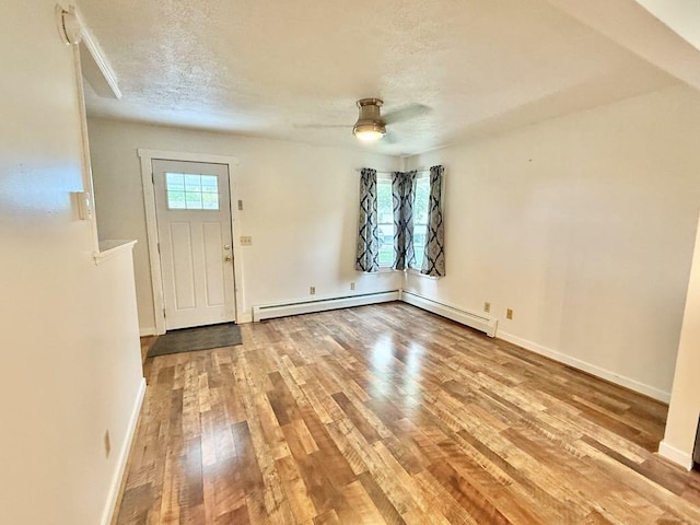 10 Turgeon St, Lewiston, ME 04240 - entrance foyer featuring wood finished floors, ceiling fan, a textured ceiling, and baseboard heating